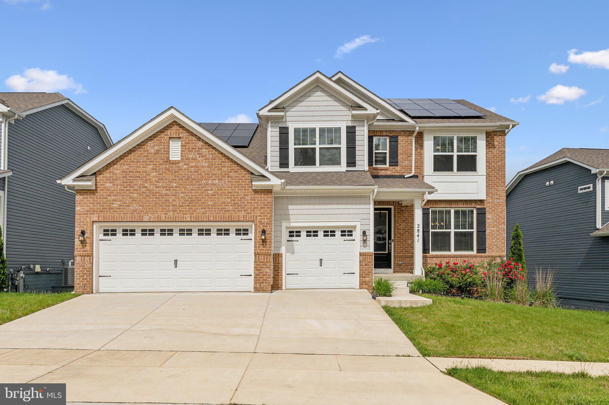 a view of a big house with a yard