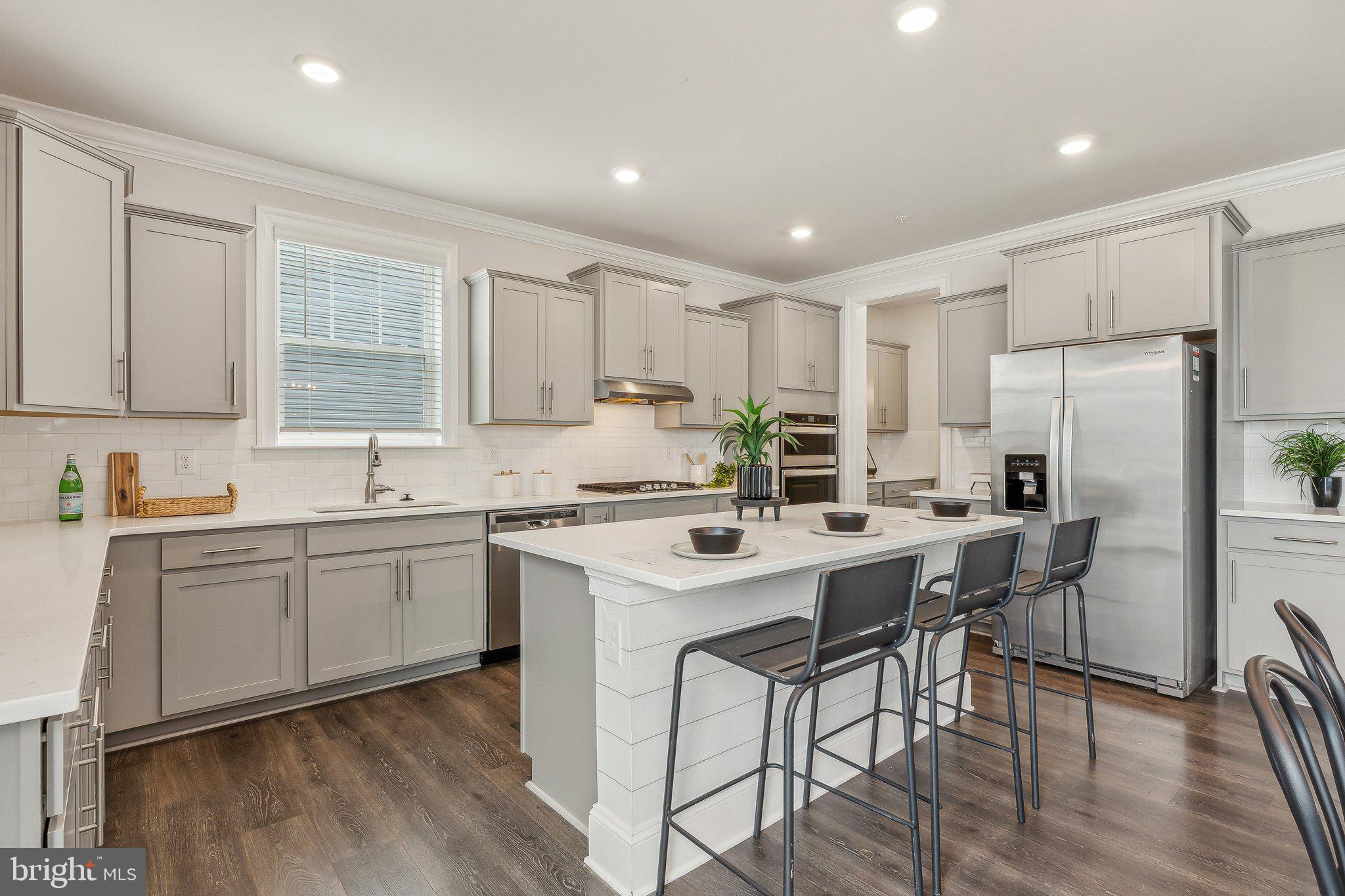 2841 Broad Wing Drive Odenton, MD 21113 - Photo 11 of 71 a kitchen with appliances a sink a counter top space and cabinets