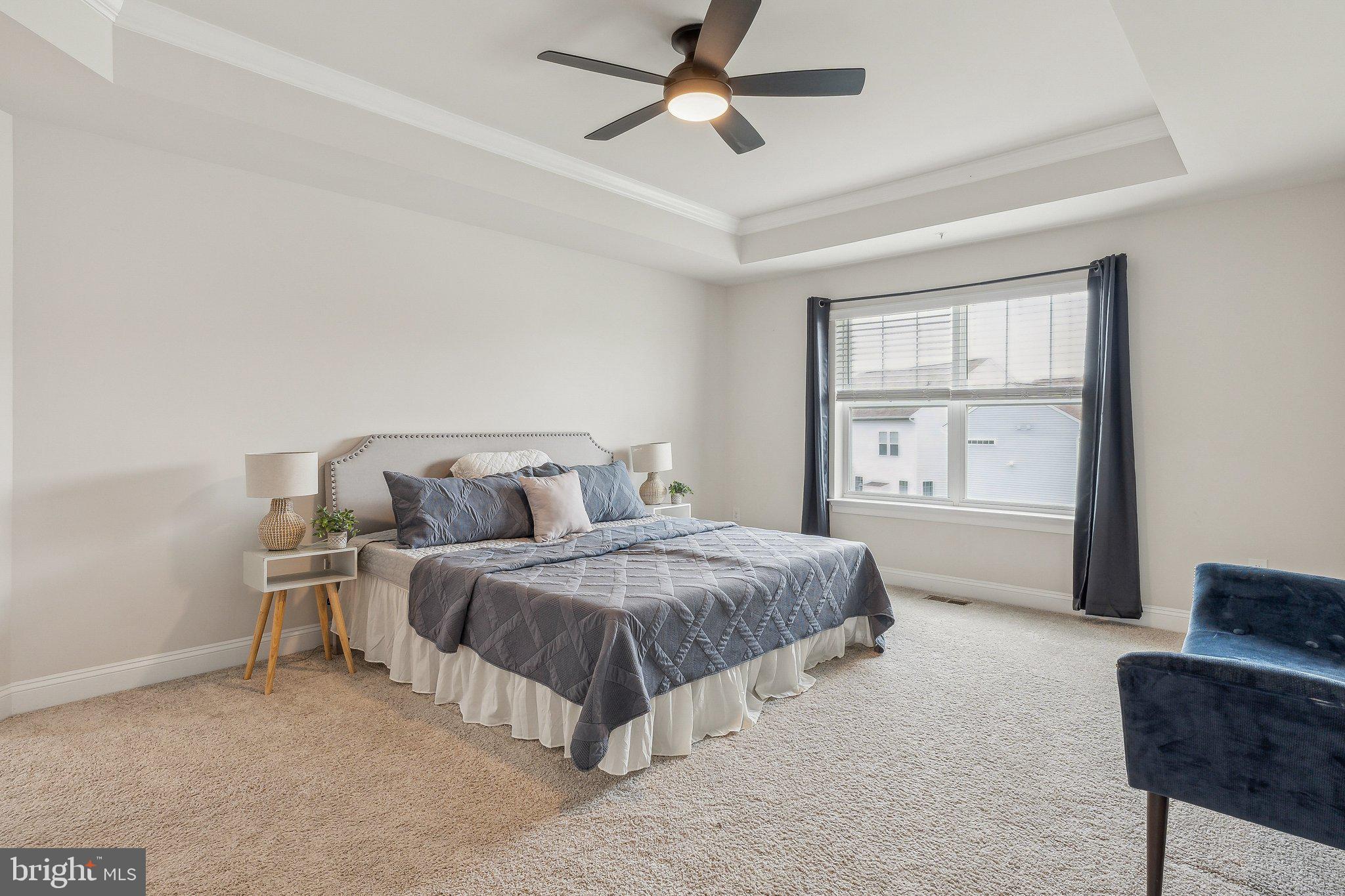 2841 Broad Wing Drive Odenton, MD 21113 - Photo 25 of 71 a spacious bedroom with a bed a window and couch