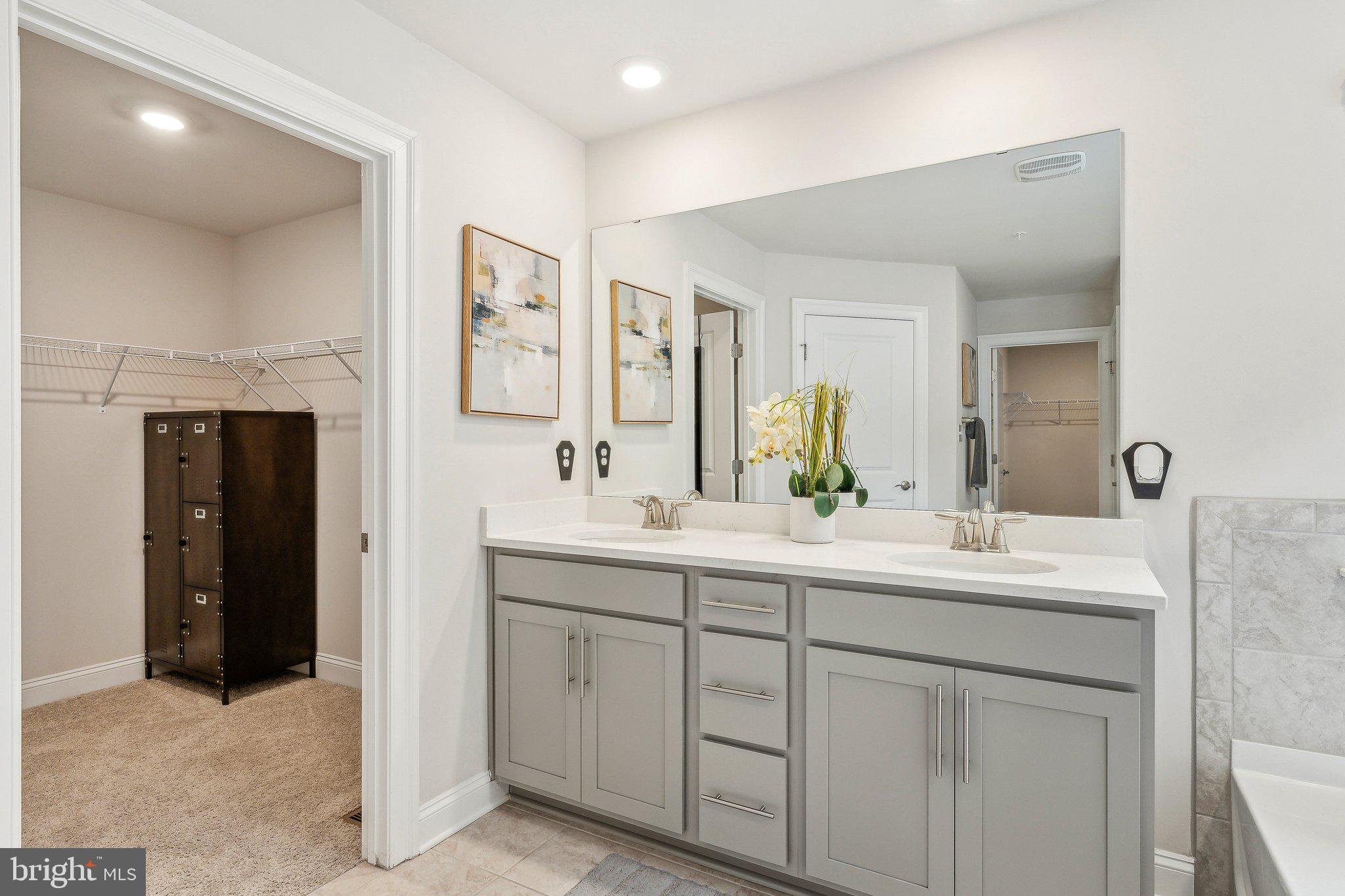 2841 Broad Wing Drive Odenton, MD 21113 - Photo 30 of 71 a bathroom with a double vanity sink and a mirror