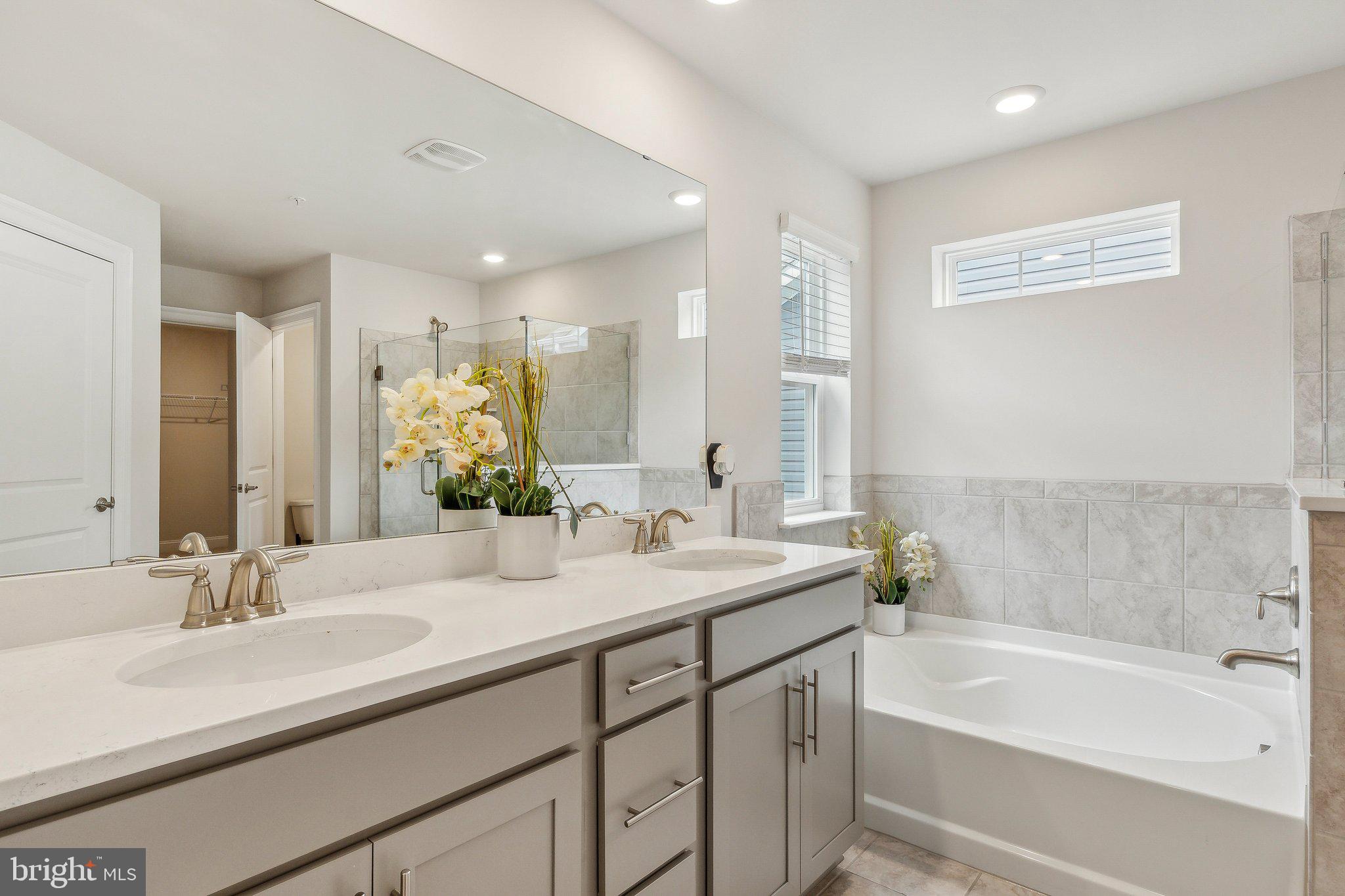 2841 Broad Wing Drive Odenton, MD 21113 - Photo 31 of 71 a bathroom with a sink double vanity granite tub shower and a mirror