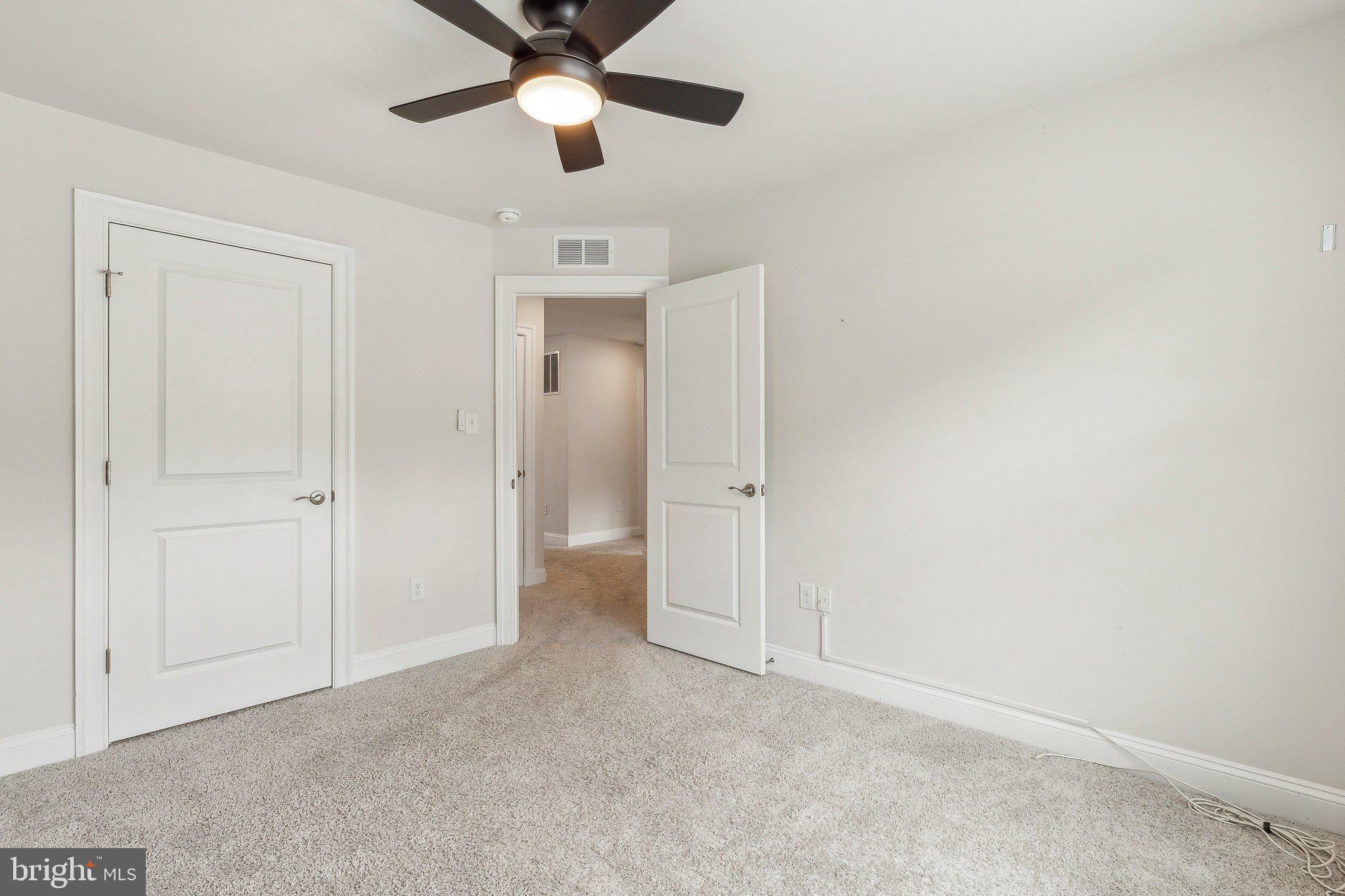 2841 Broad Wing Drive Odenton, MD 21113 - Photo 38 of 71 an empty room with a ceiling fan and carpet
