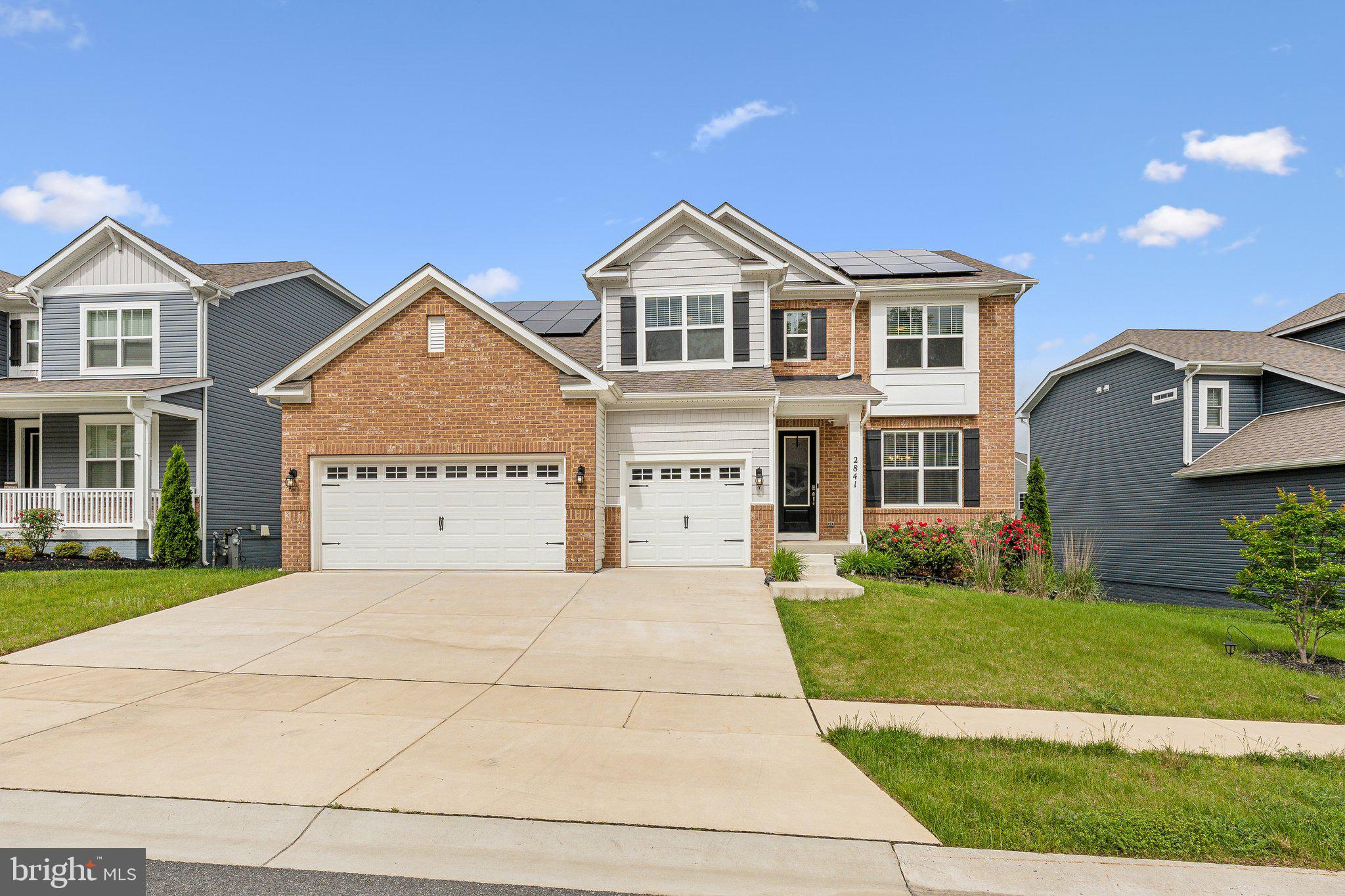 2841 Broad Wing Drive Odenton, MD 21113 - Photo 53 of 71 a view of a yard in front of a brick house with a large windows