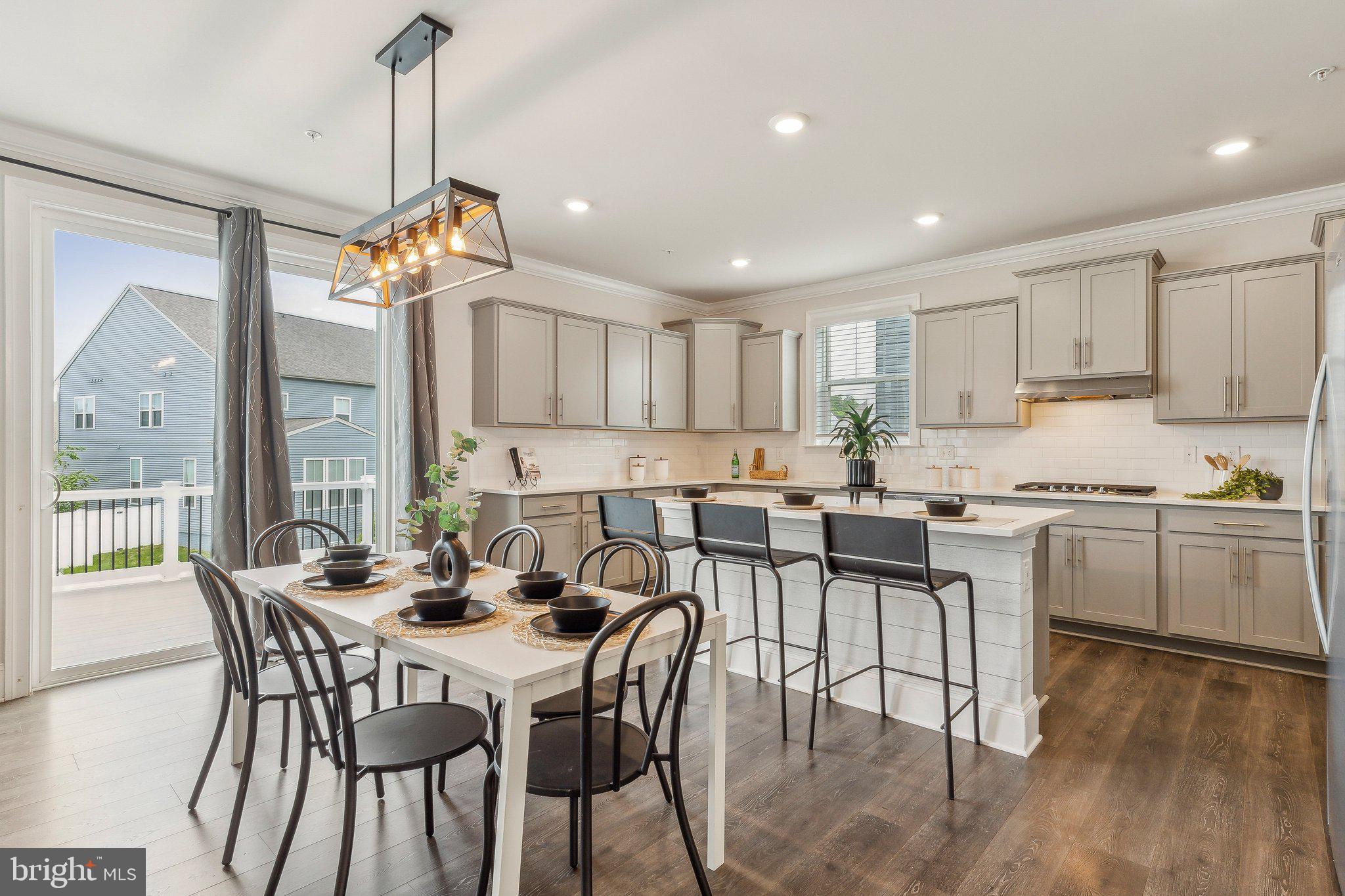 2841 Broad Wing Drive Odenton, MD 21113 - Photo 7 of 71 a view of a dining room and livingroom with furniture wooden floor a chandelier