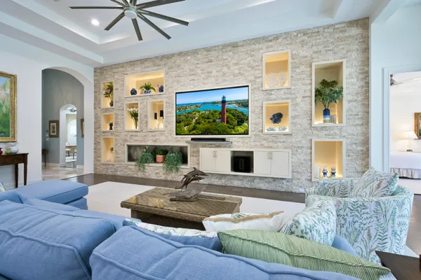 a living room with furniture a fireplace and a flat screen tv