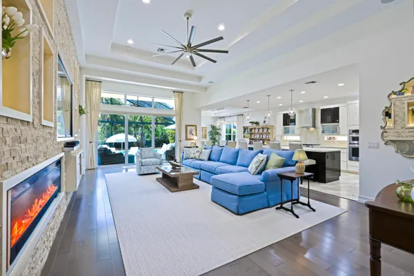 a living room with fireplace furniture and a large window