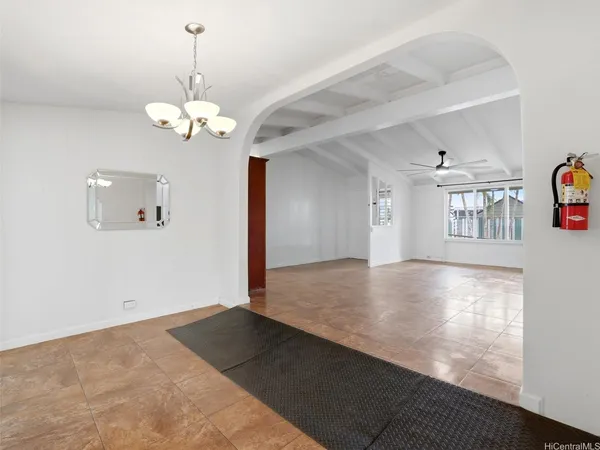 a view of empty room with wooden floor and ceiling fan