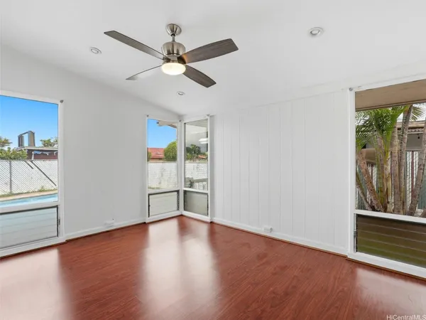 a view of a kitchen with a fridge wooden floor and a ceiling fan