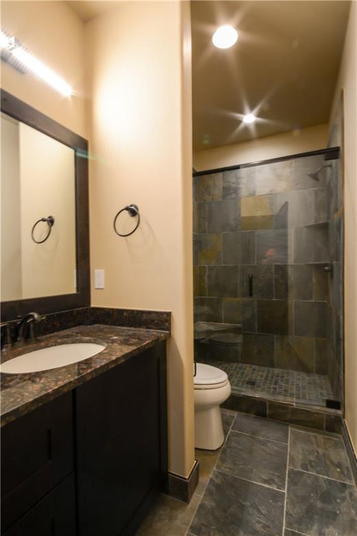 850 Independence Road, Unit 3C Keystone, CO 80435 - Photo 18 of 25 a bathroom with a granite countertop sink a toilet and shower