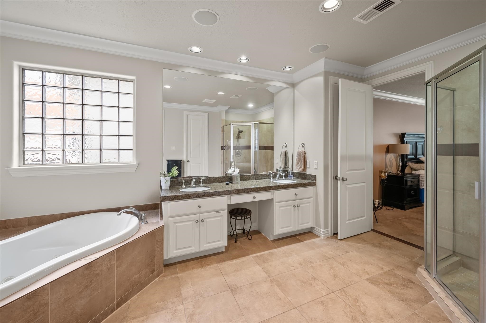 2127 Thicket Ridge Lane Houston, TX 77077 - Photo 21 of 50 The primary retreat is a sanctuary of sensory indulgence, featuring a spa-inspired bath with a deep soaking tub, a massive walk-in shower, and integrated in-ceiling speakers for an immersive escape. Thanks to the high-capacity tankless system, you can enjoy a limitless, therapeutic experience with an infinite supply of hot water—no timer, no limits, just pure relaxation.