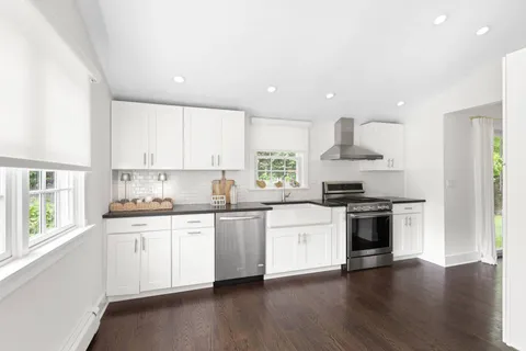 a kitchen with stainless steel appliances granite countertop a sink and stove top oven