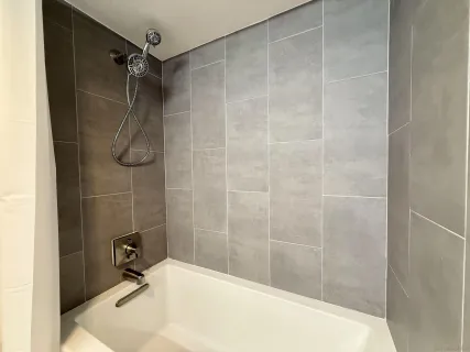 a bathroom with a shower and a bathtub