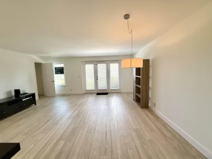 a view of a room with wooden floor and window