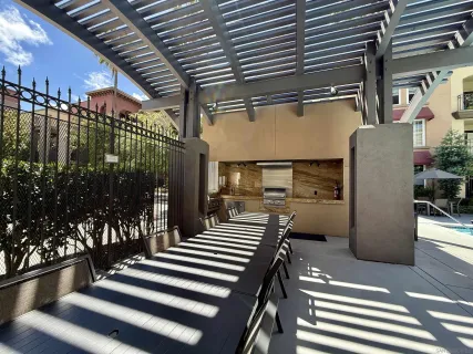 a kitchen with stainless steel appliances kitchen island granite countertop a refrigerator and a stove