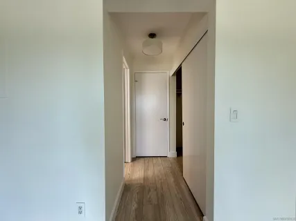 a view of hallway with wooden floor