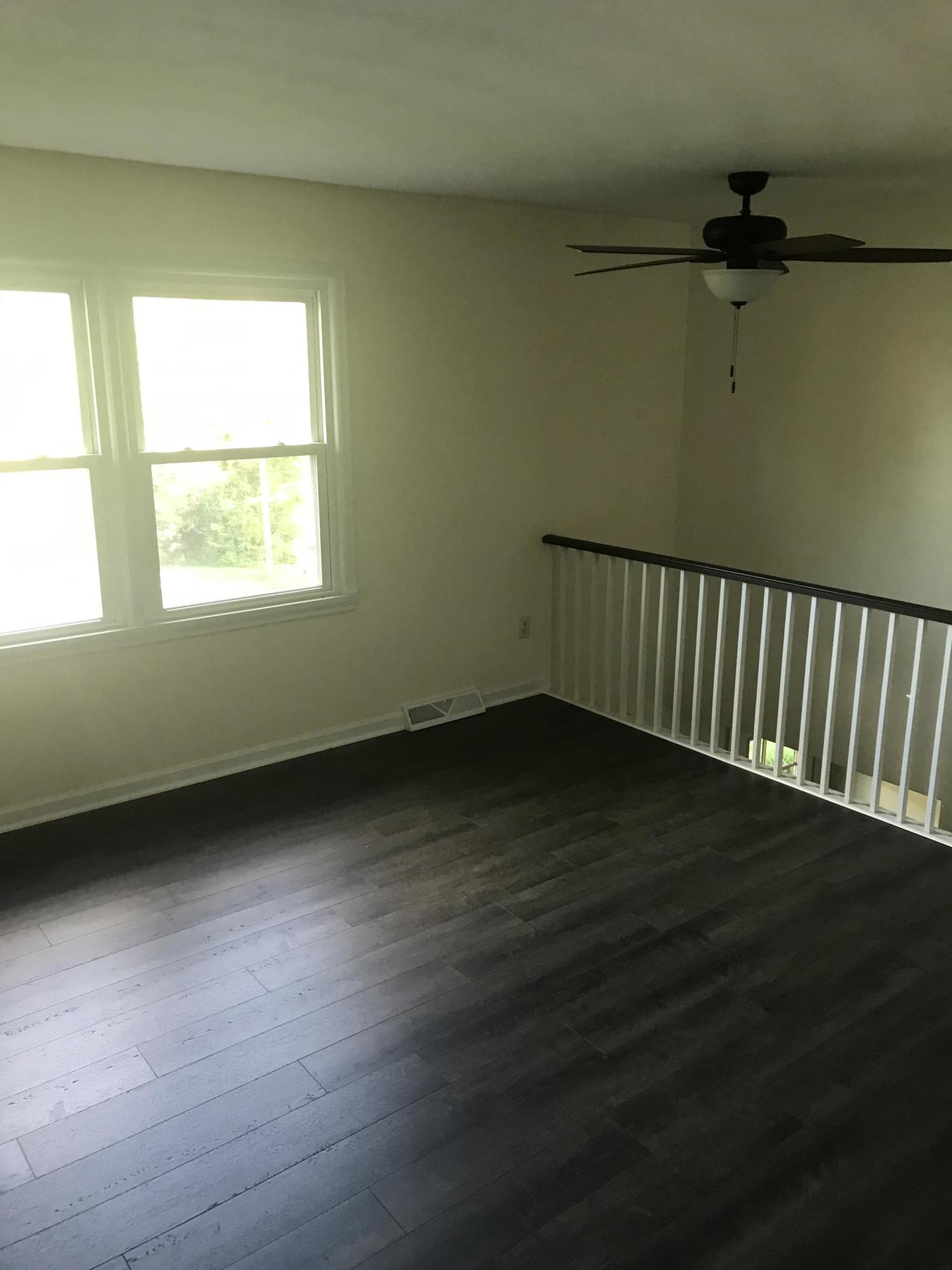 53 Almond Circle Blue Ridge, VA 24064 - Photo 15 of 21 a view of an empty room with wooden floor and a window