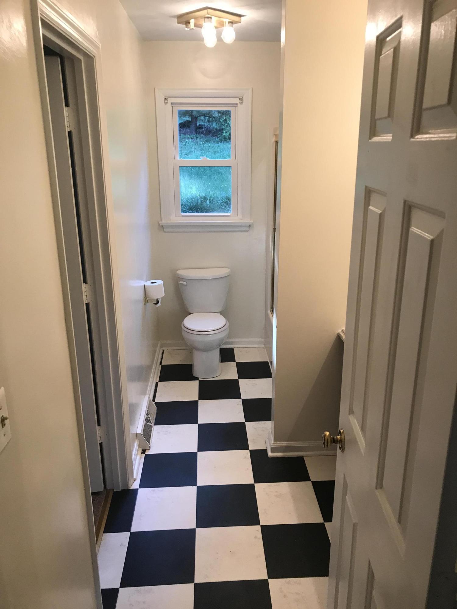 53 Almond Circle Blue Ridge, VA 24064 - Photo 16 of 21 a bathroom with a black and white checkered floor