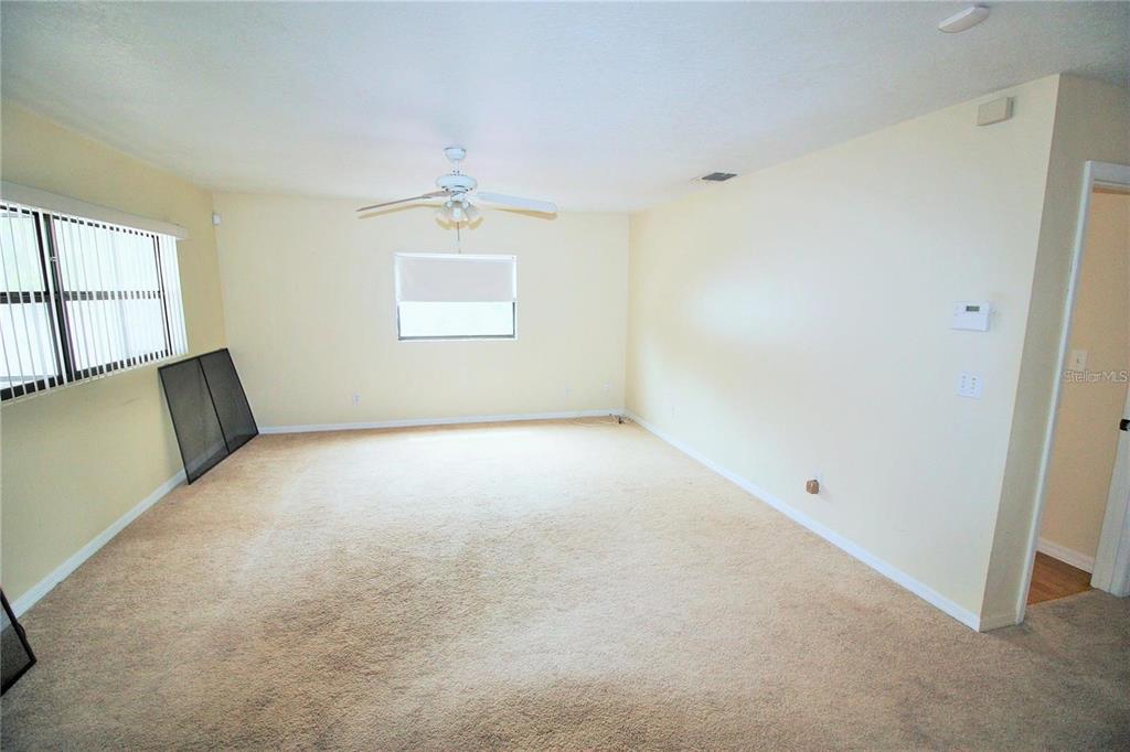 521 20th Street Southwest, Unit C Winter Haven, FL 33880 - Photo 5 of 18 wooden floor in an empty room with a window