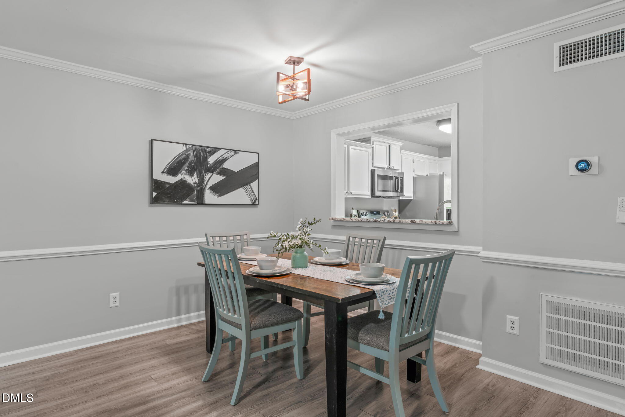 203 Oak Hollow Court Raleigh, NC 27613 - Photo 10 of 37 a view of a dining room with furniture and wooden floor