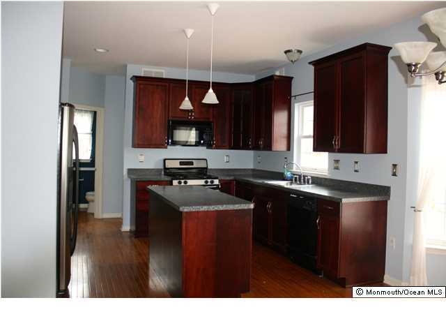 8 Cedar Knoll Road Jackson, NJ 08527 - Photo 6 of 25 a kitchen with kitchen island granite countertop a sink stainless steel appliances and cabinets