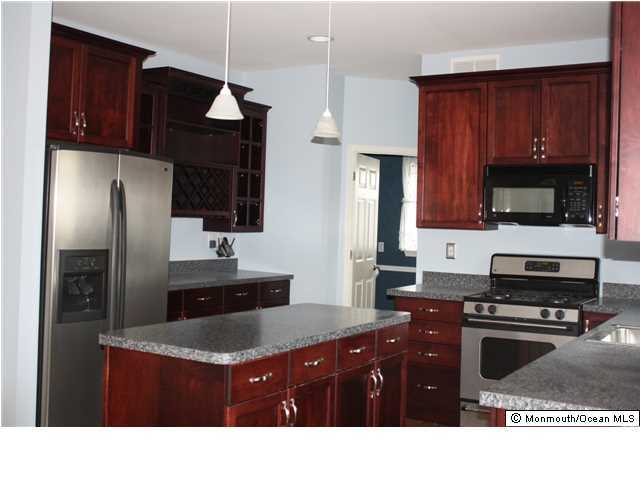 8 Cedar Knoll Road Jackson, NJ 08527 - Photo 7 of 25 a kitchen with a refrigerator a microwave a sink and cabinets