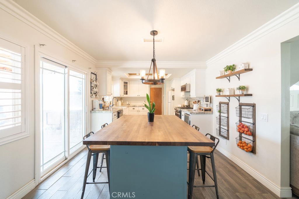 8636 Rancho Cerona Drive Paramount, CA 90723 - Photo 12 of 48 a view of a dining room with furniture window and wooden floor