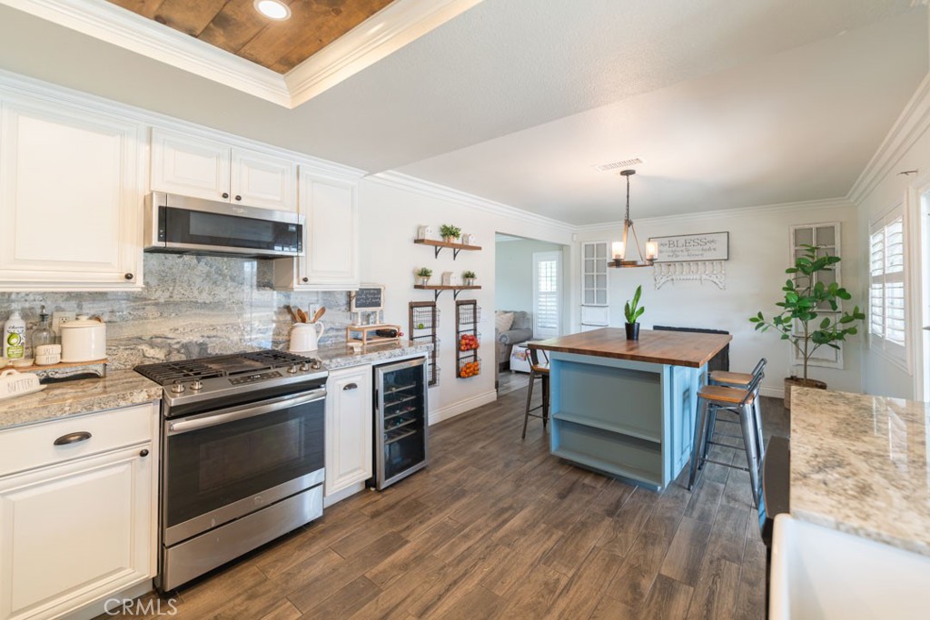 8636 Rancho Cerona Drive Paramount, CA 90723 - Photo 17 of 48 a kitchen with cabinets wooden floor and stainless steel appliances