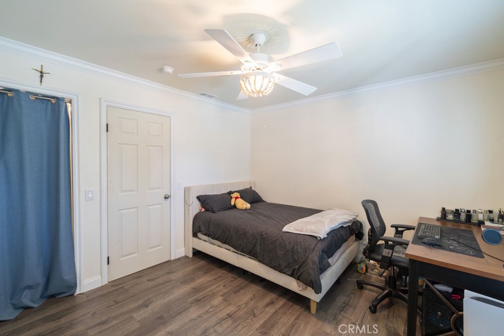 8636 Rancho Cerona Drive Paramount, CA 90723 - Photo 22 of 48 a bedroom with a bed and wooden floor