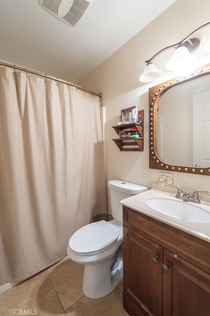 8636 Rancho Cerona Drive Paramount, CA 90723 - Photo 29 of 48 a bathroom with a sink a toilet and mirror