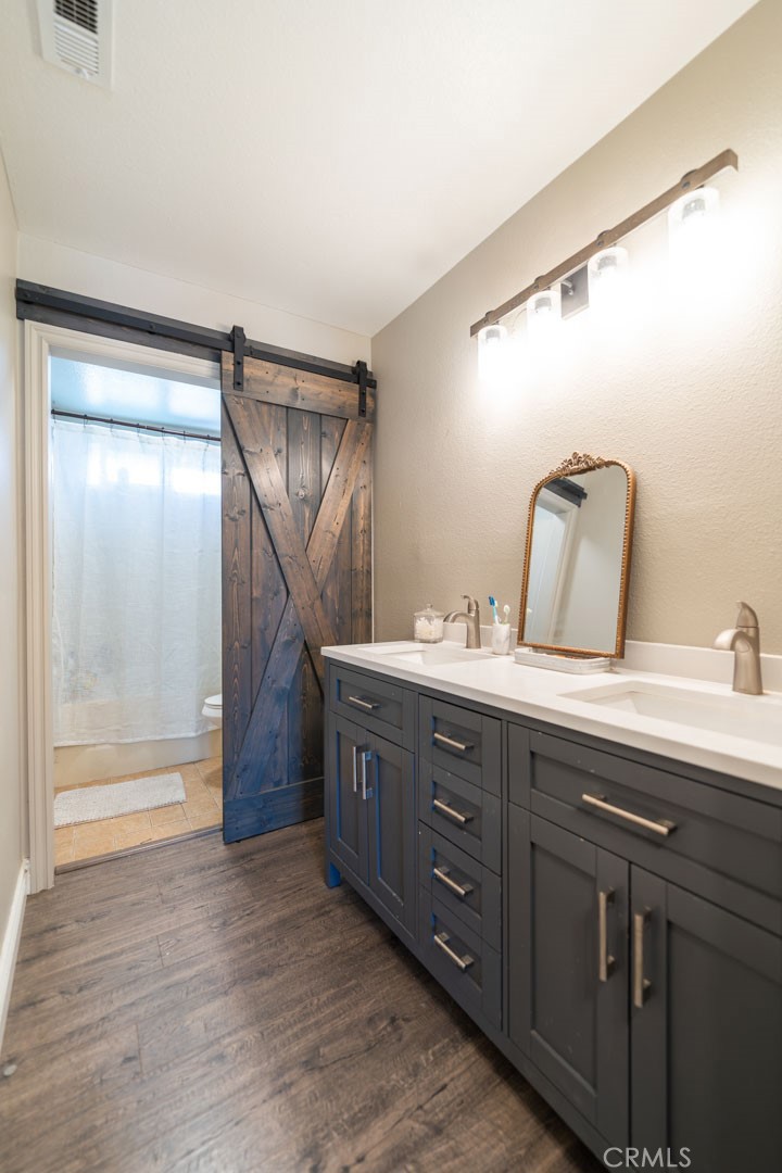 8636 Rancho Cerona Drive Paramount, CA 90723 - Photo 37 of 48 a bathroom with a double vanity sink and mirror