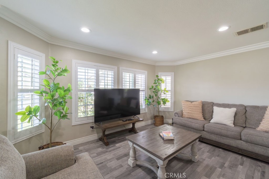 8636 Rancho Cerona Drive Paramount, CA 90723 - Photo 8 of 48 a living room with furniture and a flat screen tv