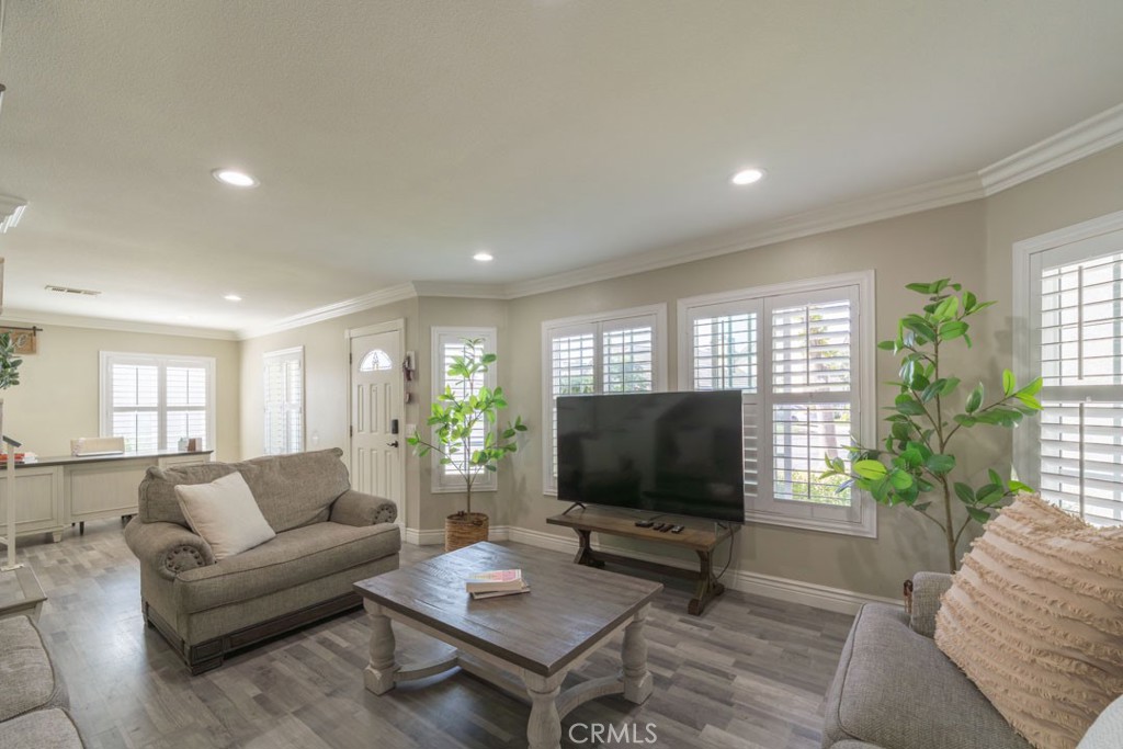 8636 Rancho Cerona Drive Paramount, CA 90723 - Photo 9 of 48 a living room with furniture and a flat screen tv
