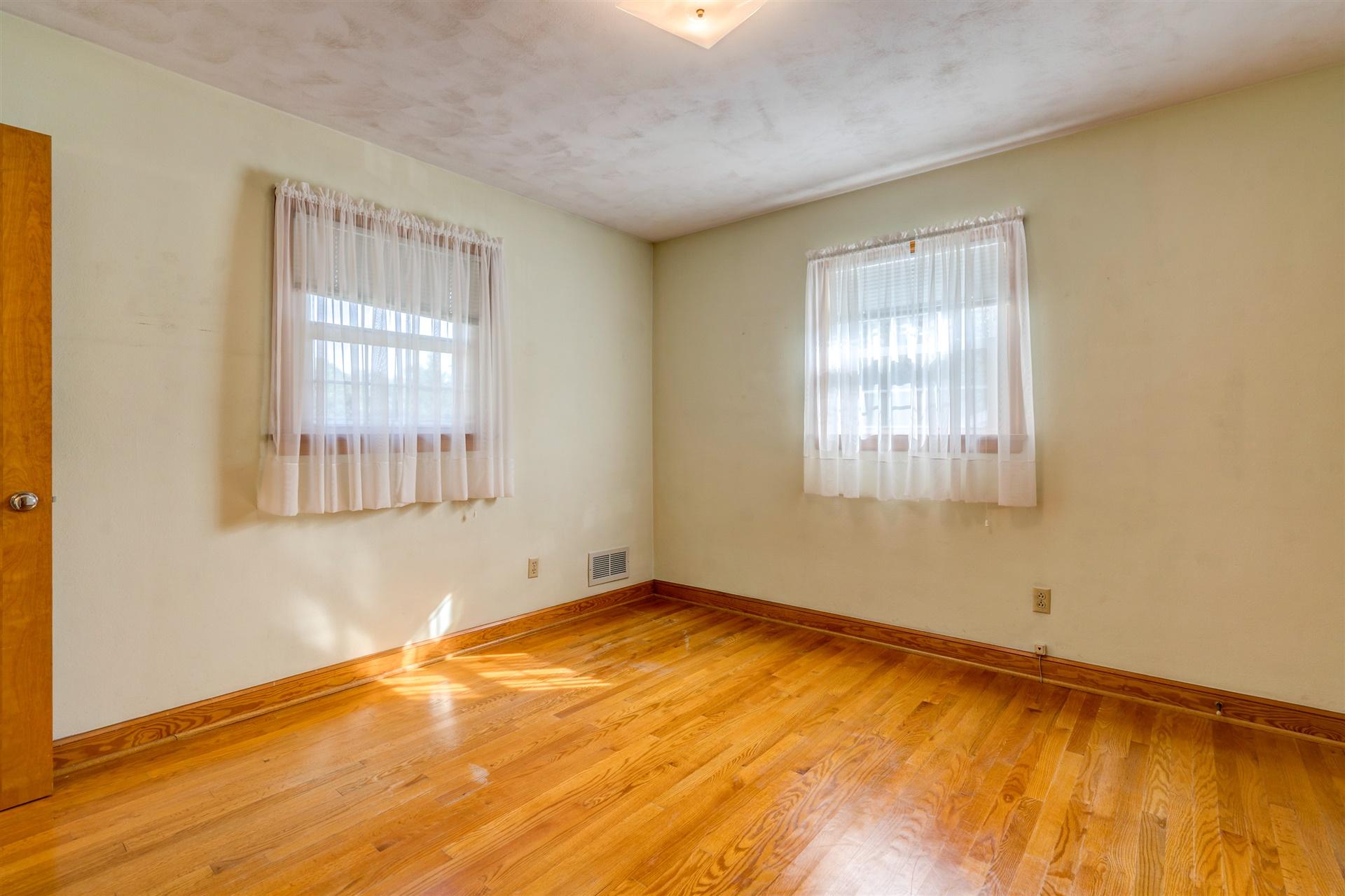 1702 Eanes Road Roanoke, VA 24014 - Photo 11 of 21 a view of an empty room with wooden floor and a window