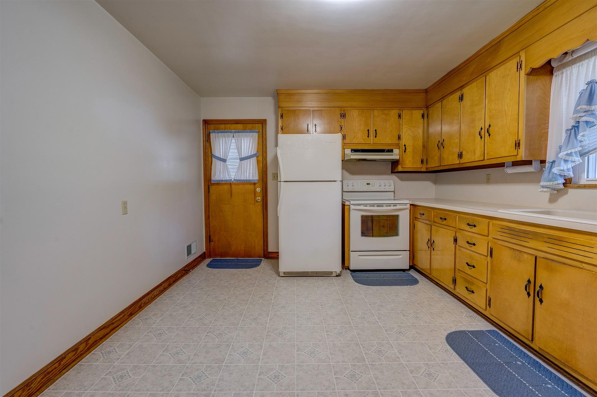 1702 Eanes Road Roanoke, VA 24014 - Photo 6 of 21 a kitchen with stainless steel appliances a refrigerator and a stove