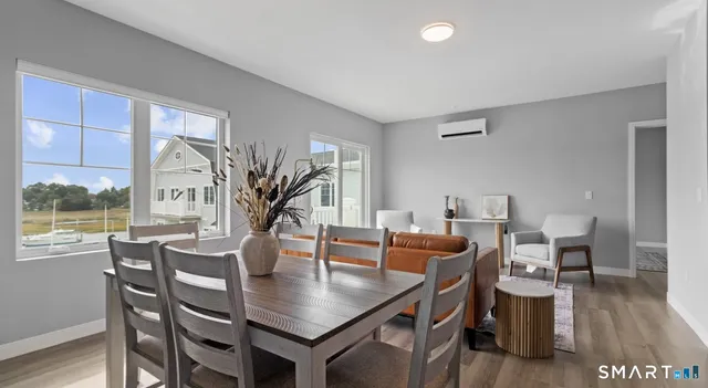a view of a dining room with furniture window and wooden floor