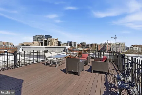a view of a roof deck with furniture