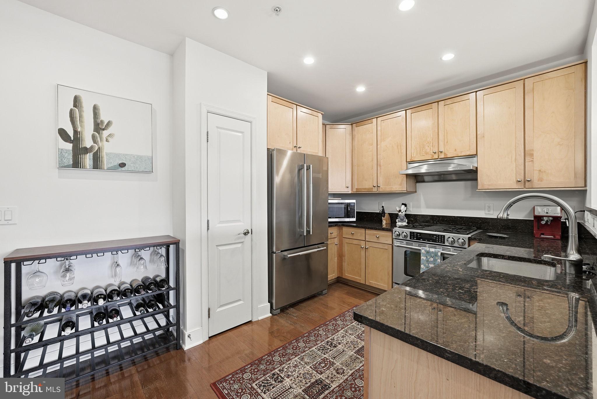 1511 North Rolfe Street, Unit A303 Arlington, VA 22209 - Photo 3 of 21 a kitchen with stainless steel appliances granite countertop a refrigerator sink and stove