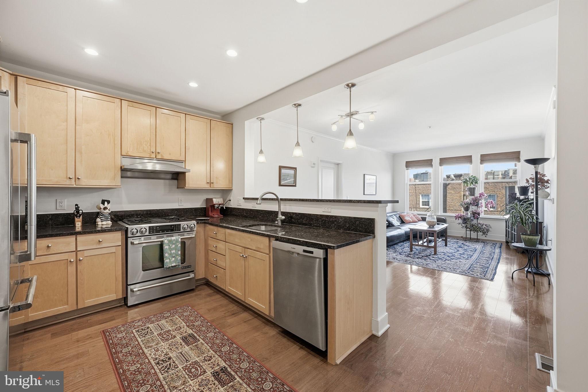 1511 North Rolfe Street, Unit A303 Arlington, VA 22209 - Photo 4 of 21 a kitchen with stainless steel appliances granite countertop a stove and a sink