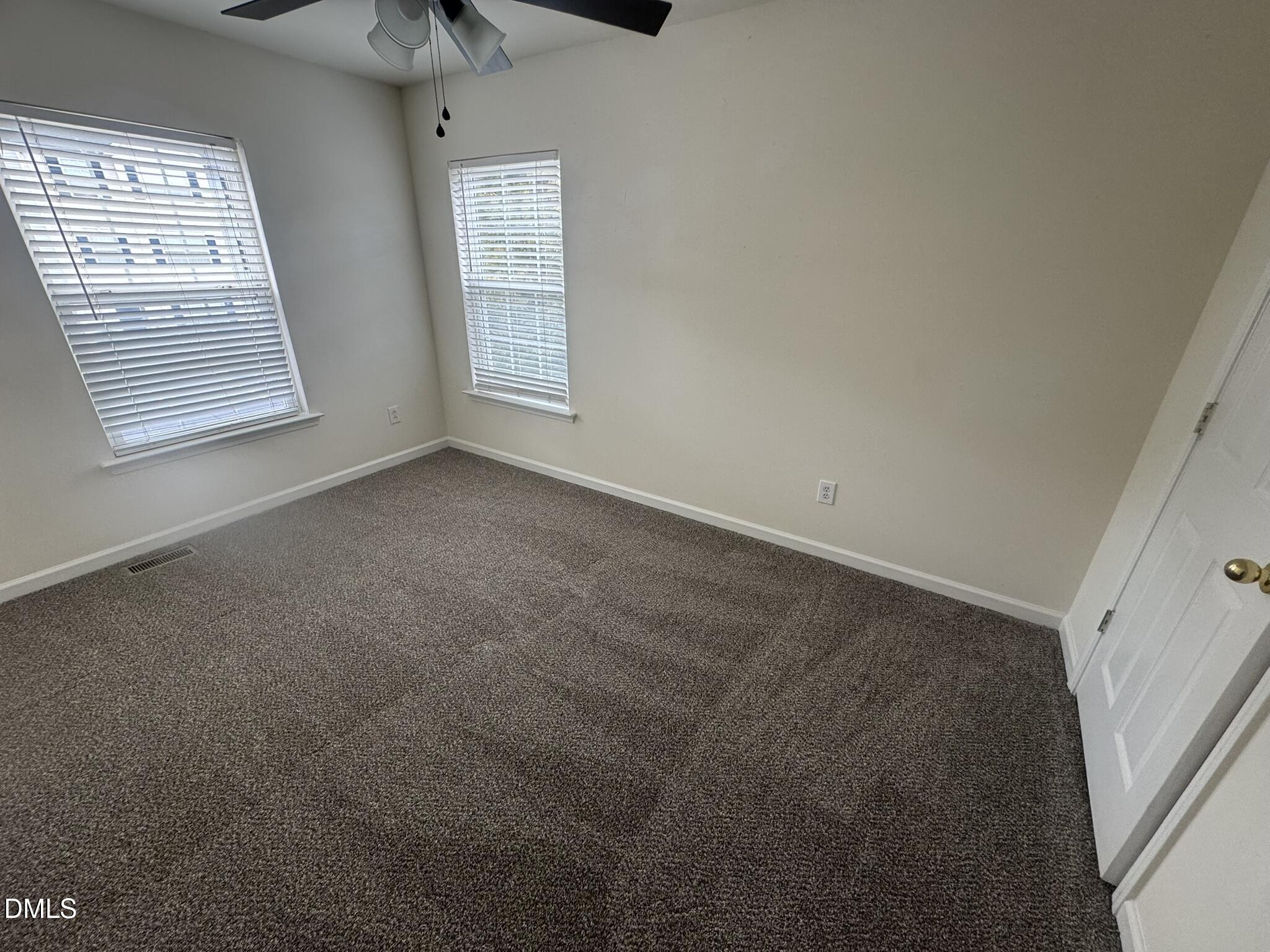 3011 Barrymore Street, Unit 100 Raleigh, NC 27603 - Photo 8 of 9 an empty room with windows