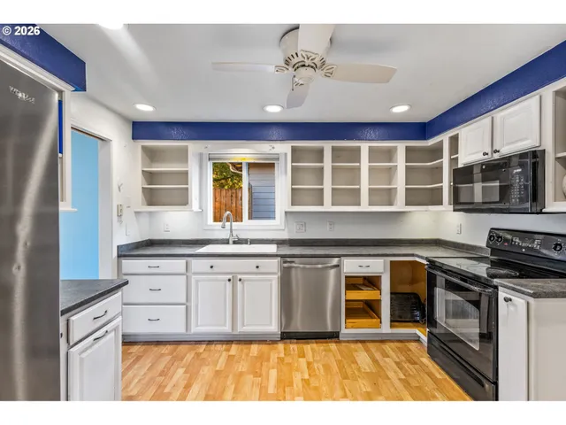 a view of an empty room with window and fire place