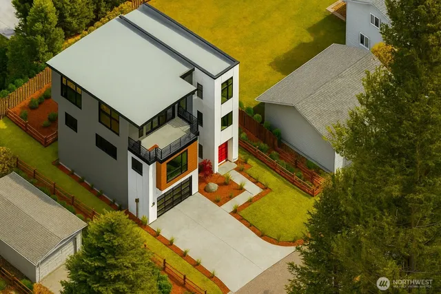 an aerial view of residential house with pool and trees