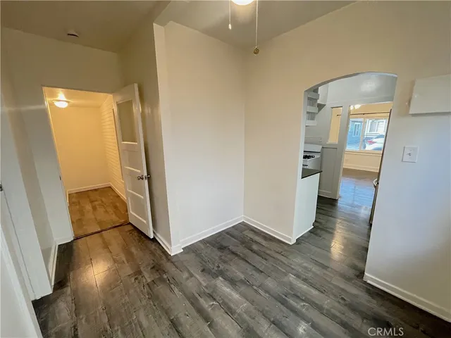 a view of a room with wooden floor