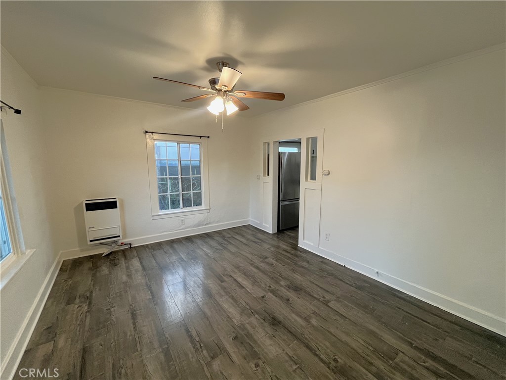 1588 West 37th Street, Unit 1/2 Los Angeles, CA 90018 - Photo 4 of 17 a view of empty room with wooden floor and fan