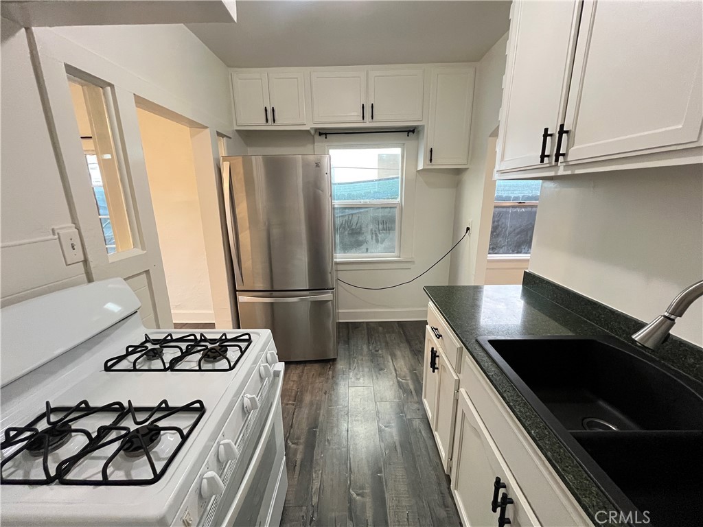 1588 West 37th Street, Unit 1/2 Los Angeles, CA 90018 - Photo 7 of 17 a kitchen with stainless steel appliances a sink a stove a refrigerator and cabinets