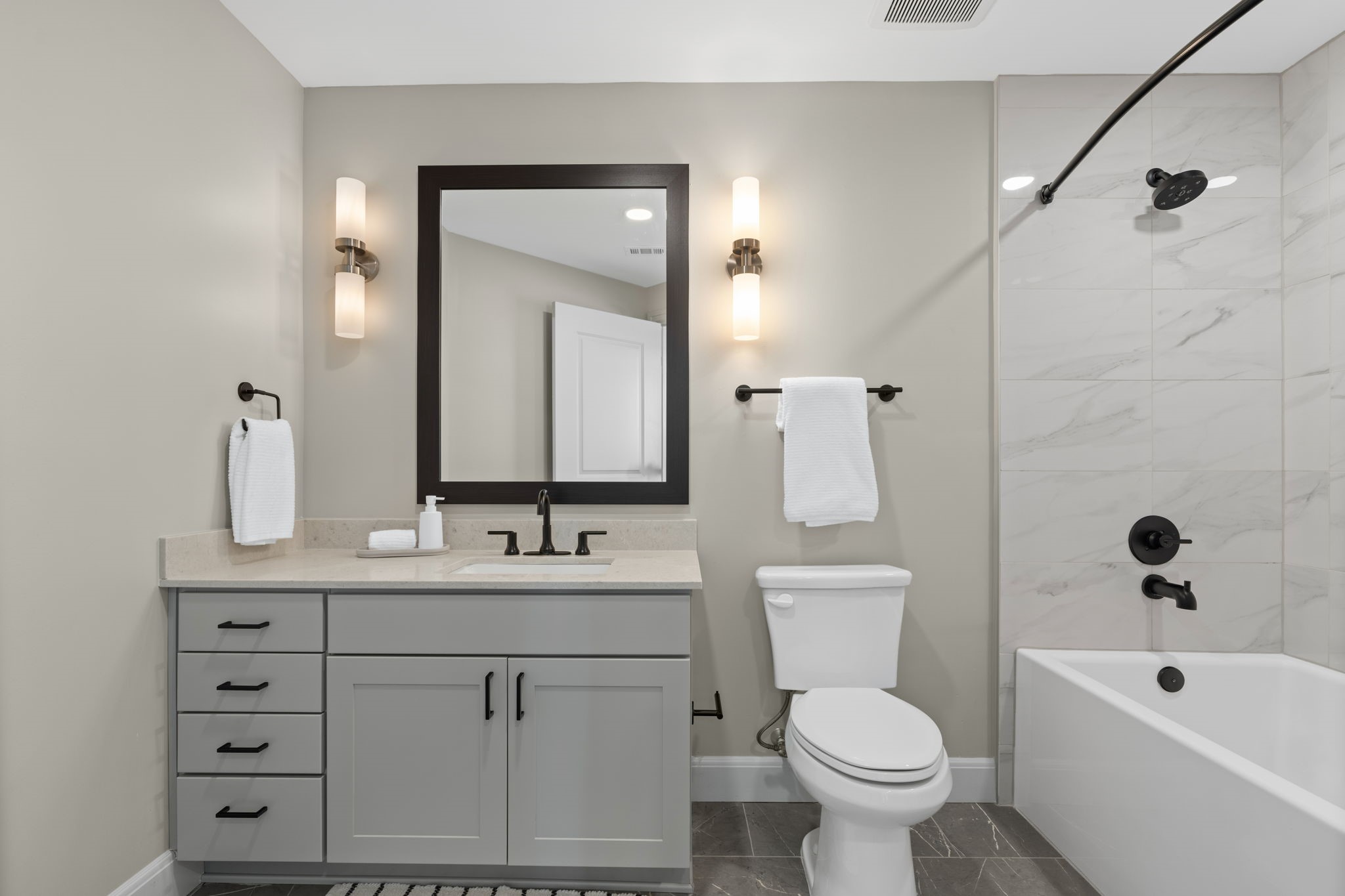 2511 Willowick Road, Unit 317 Houston, TX 77027 - Photo 12 of 44 a bathroom with a toilet sink and mirror