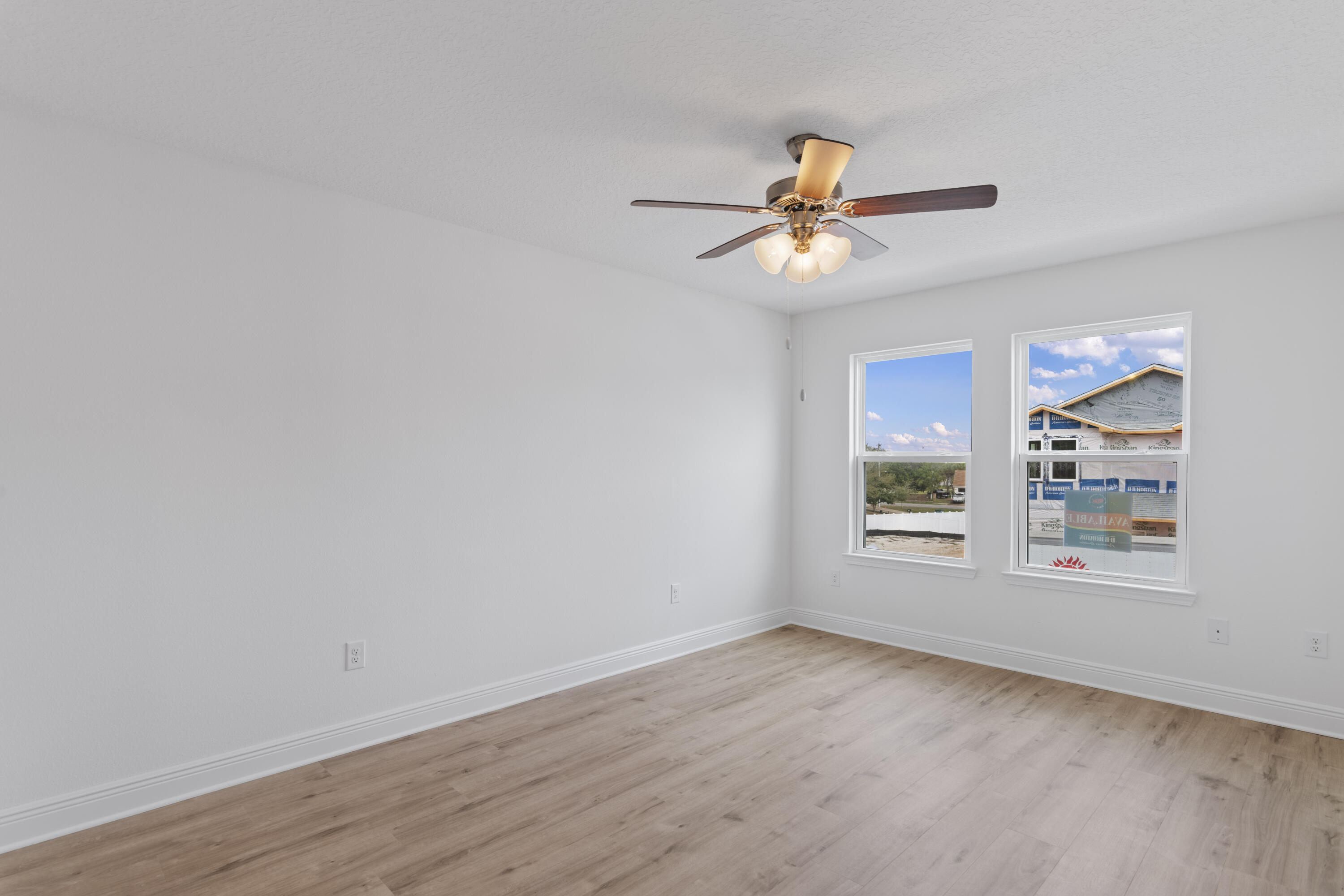 4 Renea Cove Destin, FL 32541 - Photo 14 of 21 an empty room with wooden floor ceiling fan and window