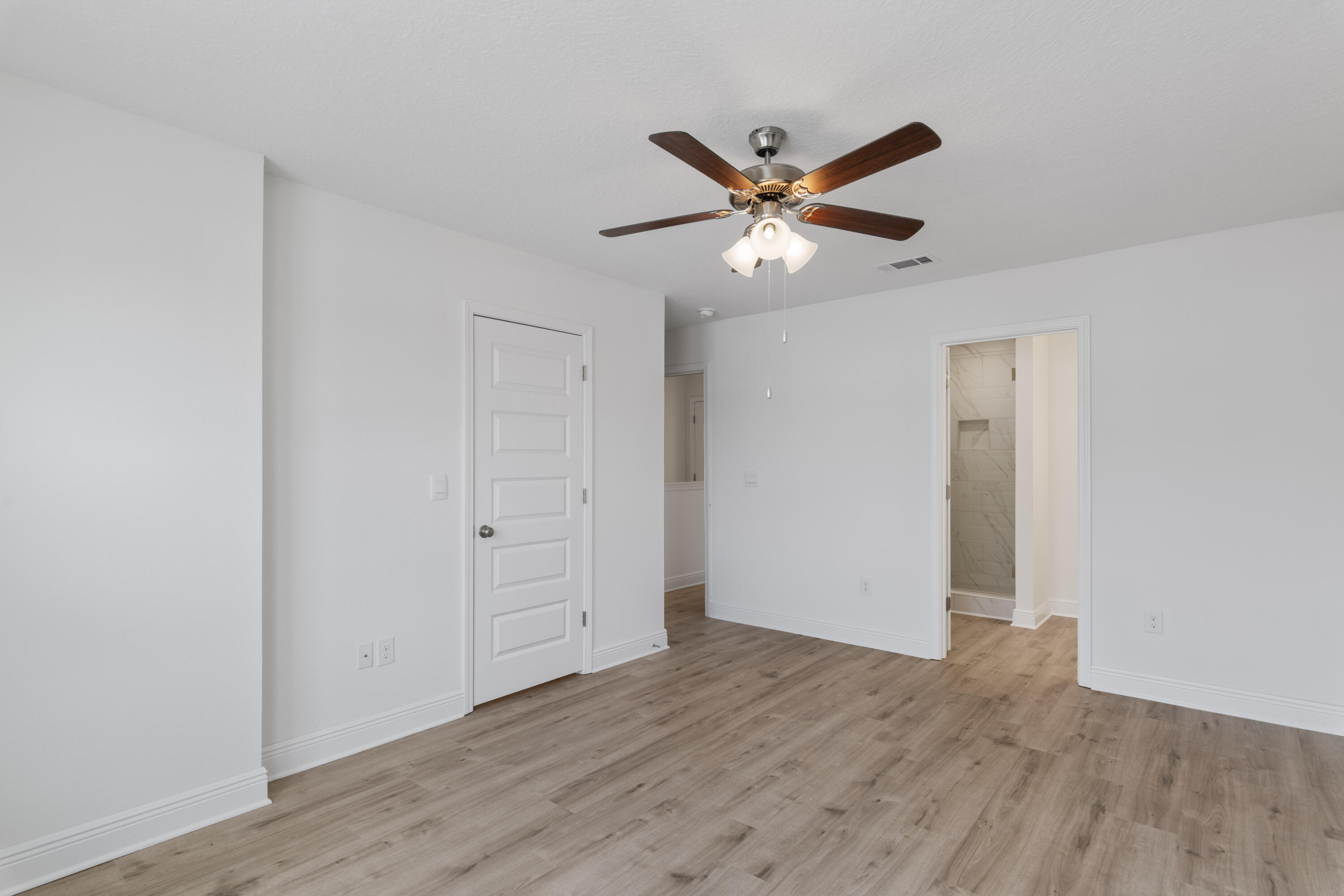 4 Renea Cove Destin, FL 32541 - Photo 16 of 21 an empty room with wooden floor closet and fan