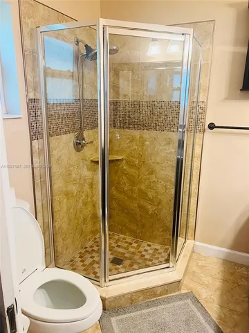 a bathroom with a shower and a toilet