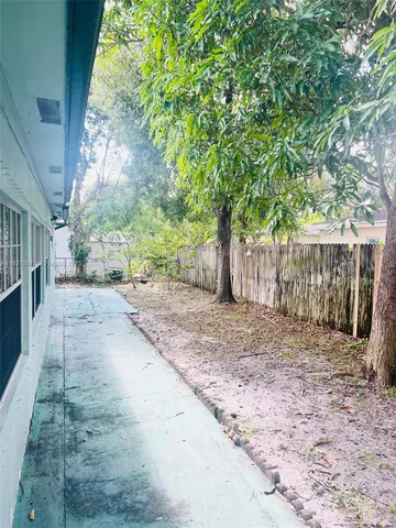 a view of a yard with wooden fence