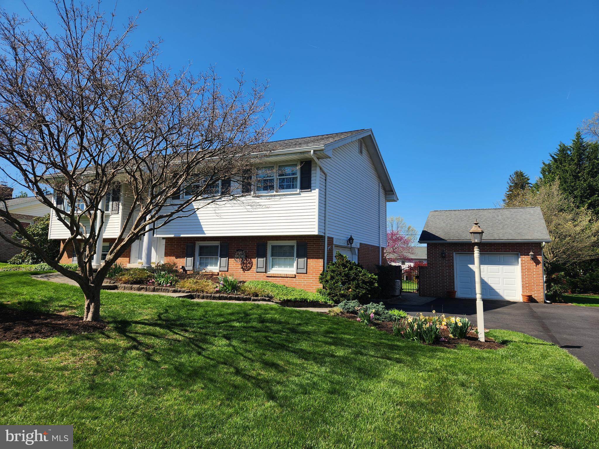 1116 Devonshire Road Lancaster, PA 17601 - Photo 45 of 70 a front view of a house with a garden and trees